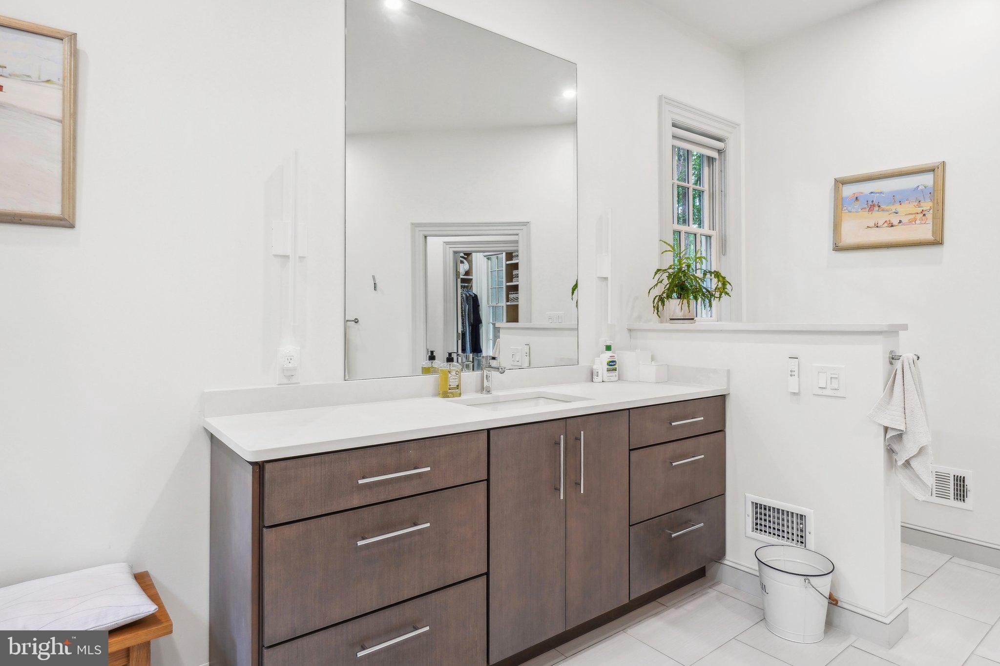 8683 Reservoir Road Fulton, MD 20759 - Photo 32 of 60 a bathroom with a toilet a sink a vanity and mirror