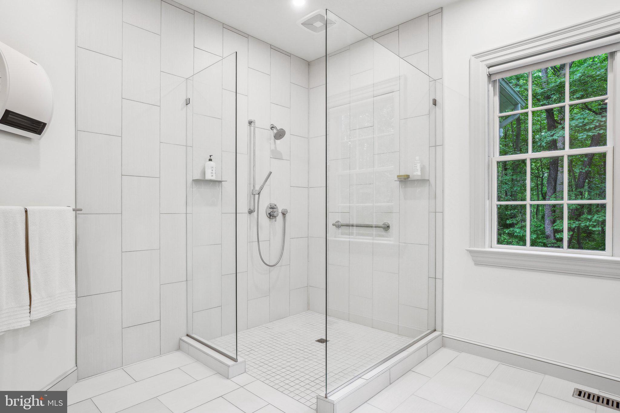 8683 Reservoir Road Fulton, MD 20759 - Photo 33 of 60 a bathroom with a glass shower door