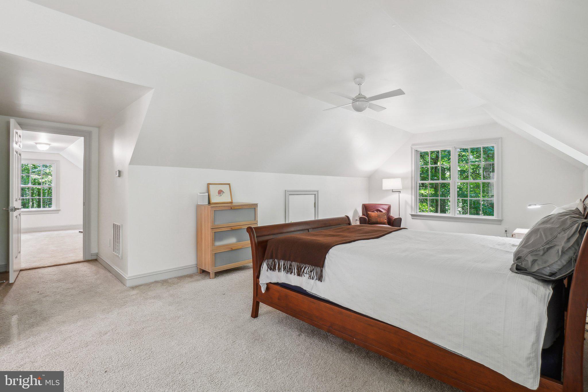 8683 Reservoir Road Fulton, MD 20759 - Photo 43 of 60 a bedroom with a large bed and a chandelier