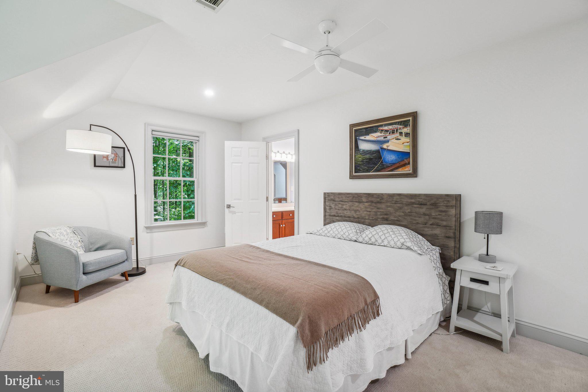 8683 Reservoir Road Fulton, MD 20759 - Photo 44 of 60 a spacious bedroom with a bed and a couch
