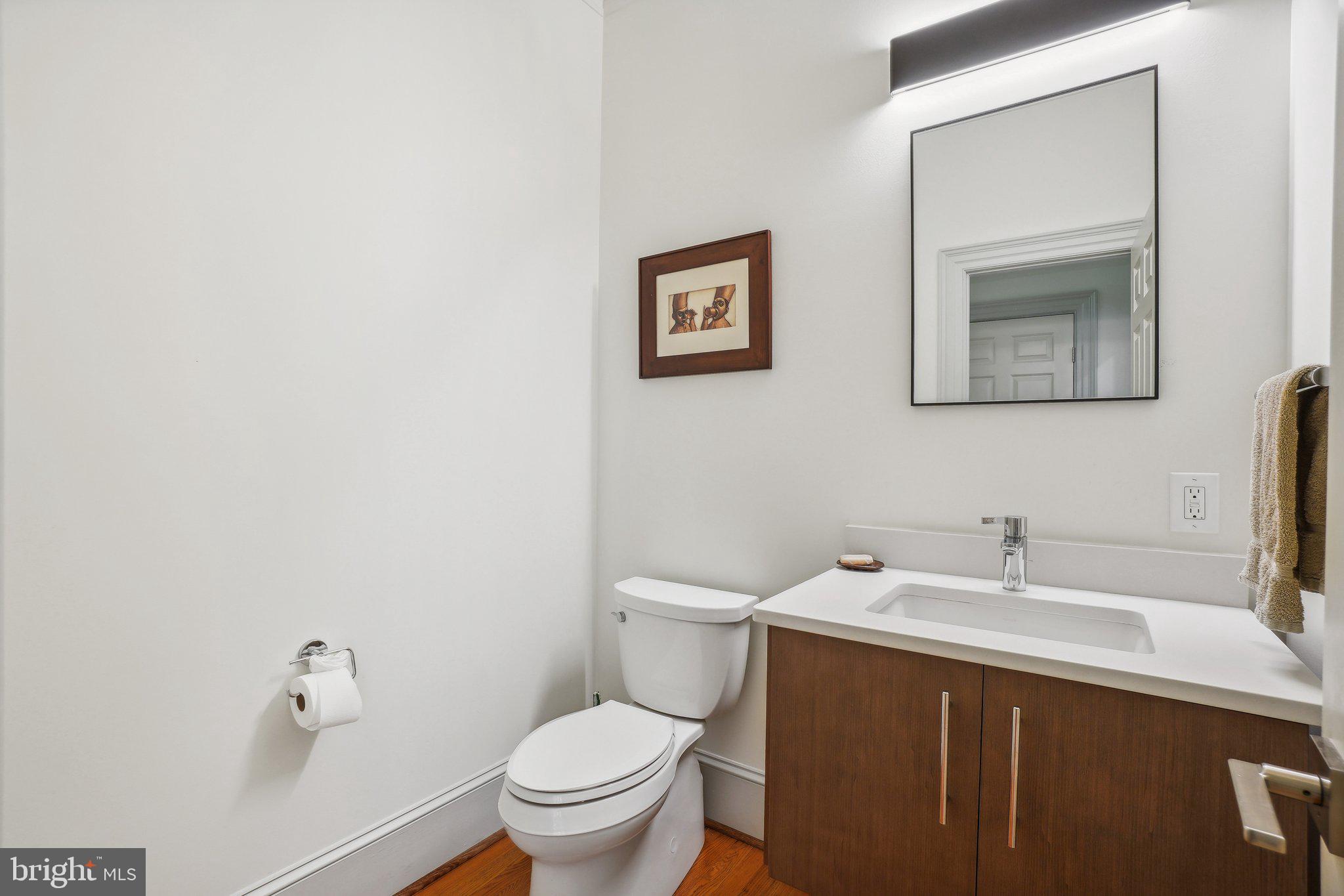 8683 Reservoir Road Fulton, MD 20759 - Photo 51 of 60 a bathroom with a toilet a sink and mirror