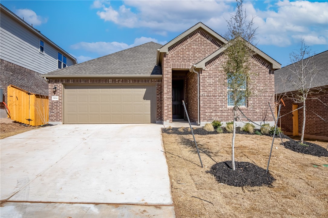 a view of a house with a wooden bench