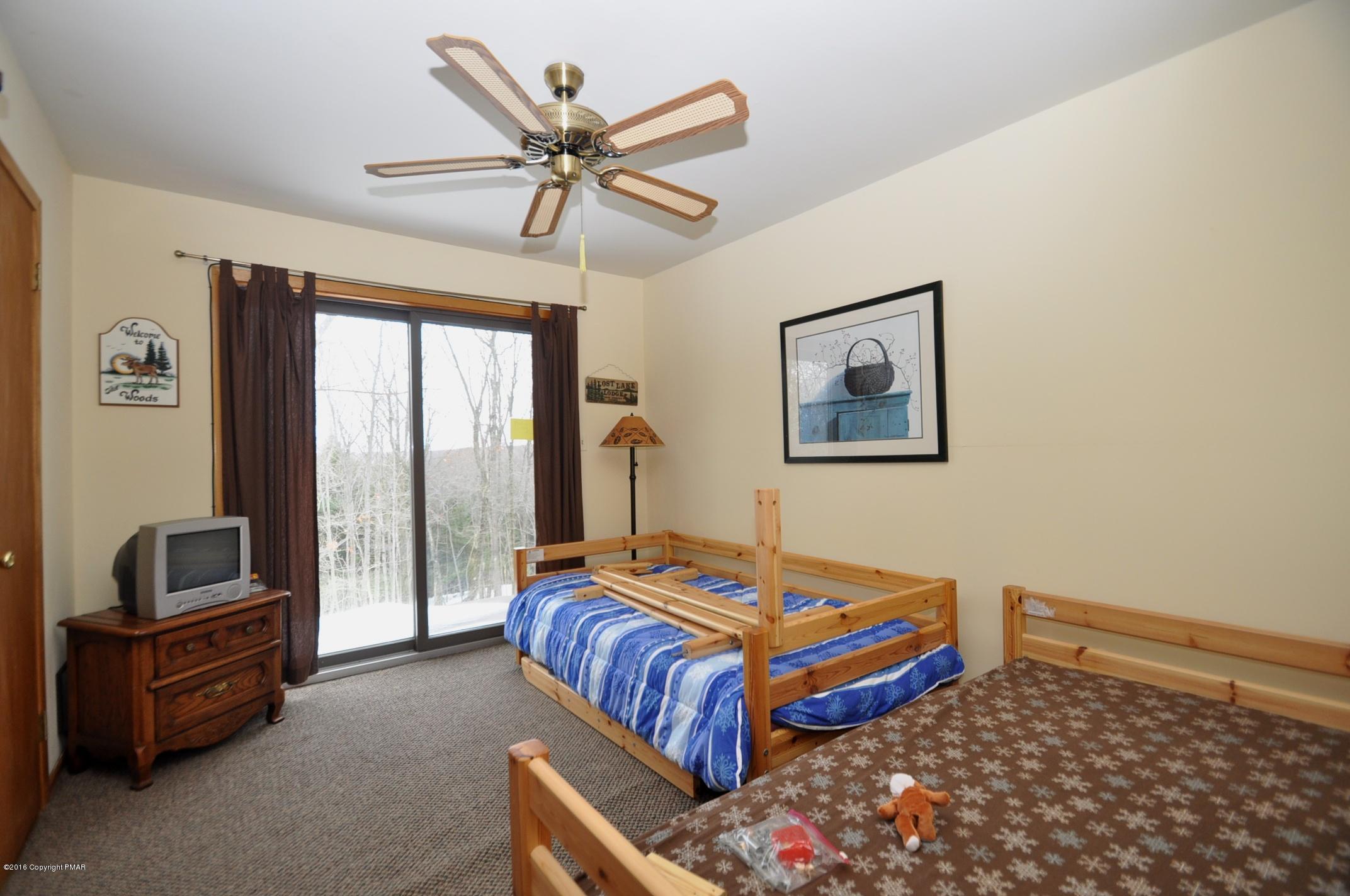 2 Brier Crest Road Blakeslee, PA 18610 - Photo 11 of 15 a bedroom with a bed and a chandelier