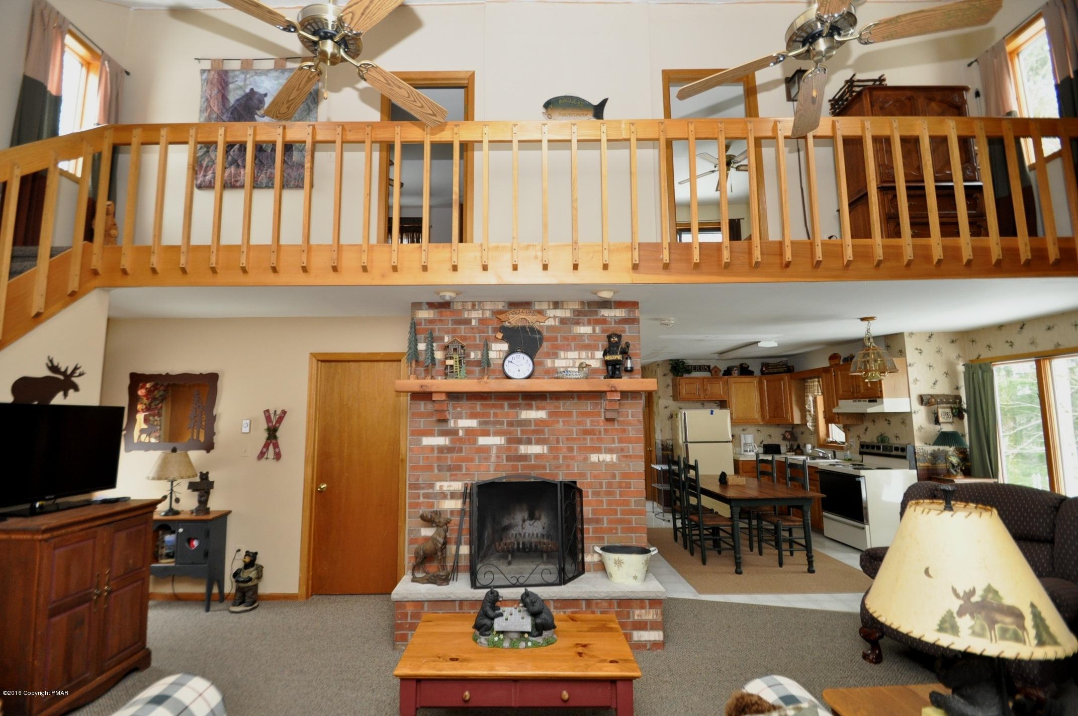 2 Brier Crest Road Blakeslee, PA 18610 - Photo 3 of 15 a living room with furniture a fireplace and a large window