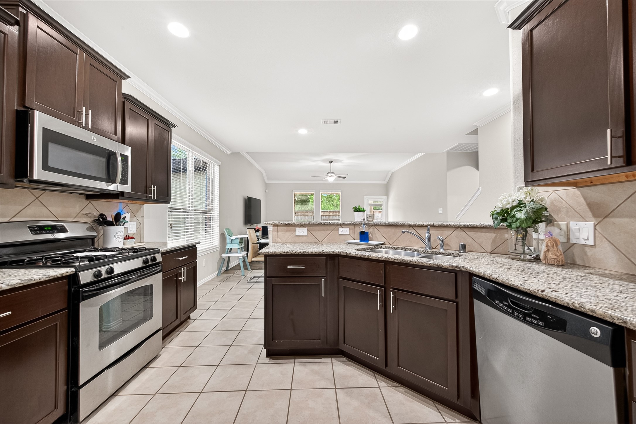 8 Landscape Court Conroe, TX 77301 - Photo 20 of 43 a kitchen with stainless steel appliances granite countertop a sink and stove top oven