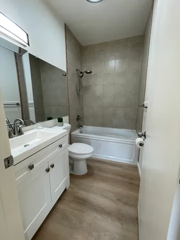 walk in closet with wooden floor