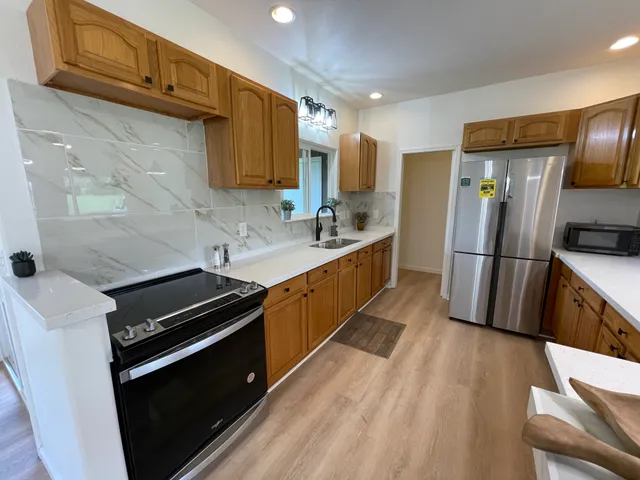 a kitchen with wooden cabinets and a stainless steel appliances