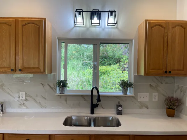 a view of a kitchen with a table and chairs