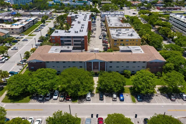 an aerial view of a house with a yard and large trees