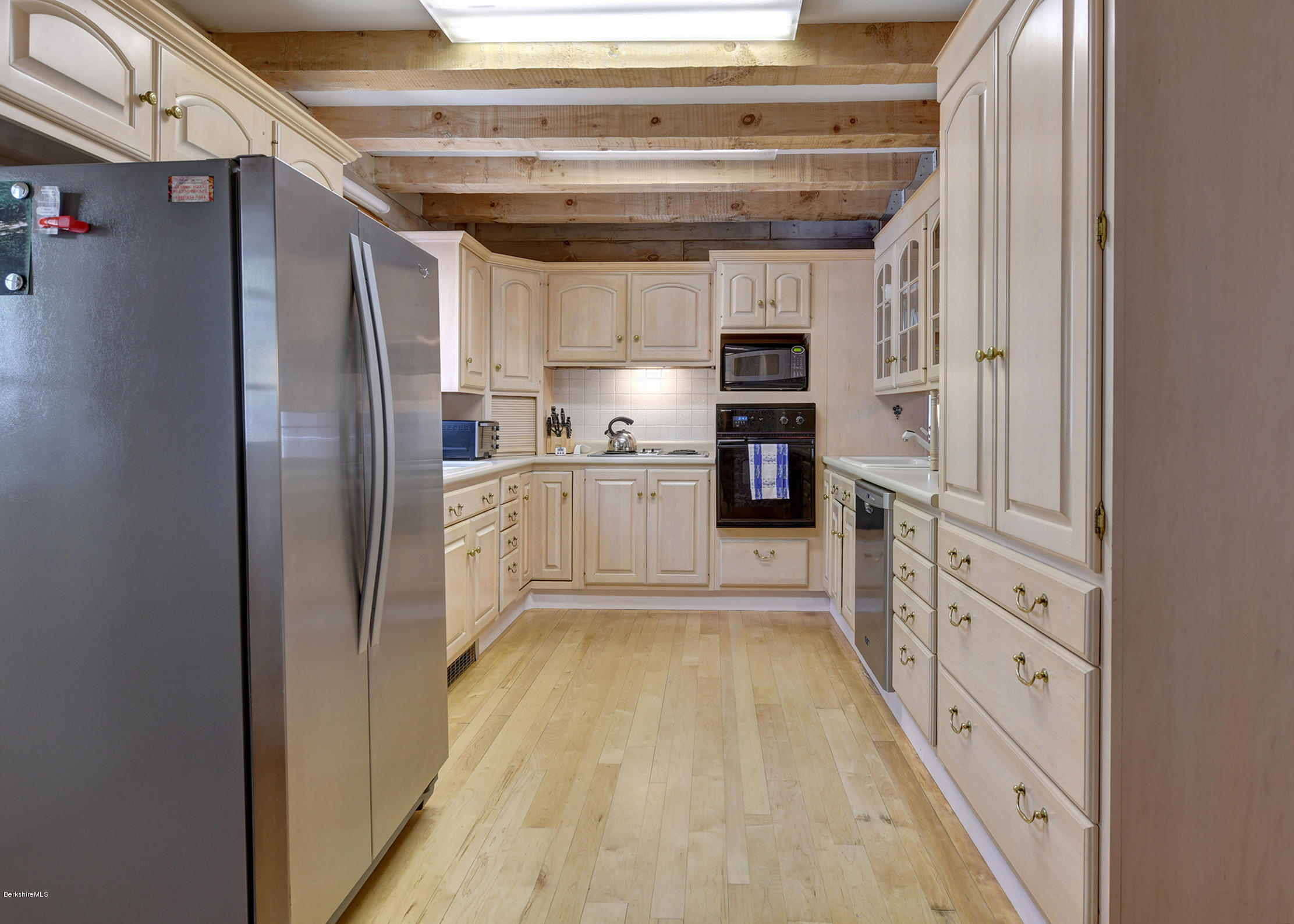 251 Captain Whitney Road Becket, MA 01223 - Photo 14 of 37 a kitchen with stainless steel appliances granite countertop a refrigerator and a stove