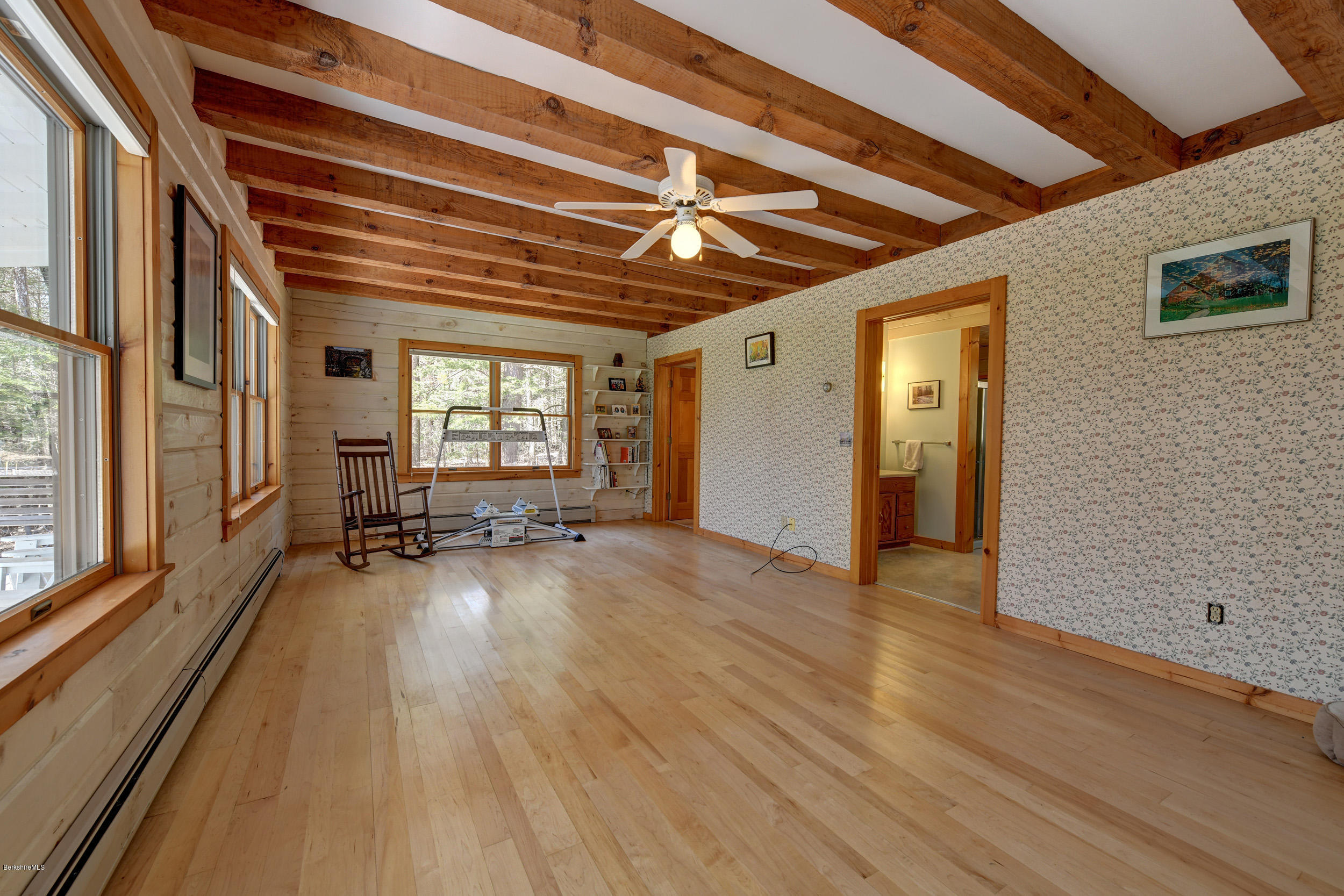 251 Captain Whitney Road Becket, MA 01223 - Photo 16 of 37 a view of empty room with wooden floor and fan