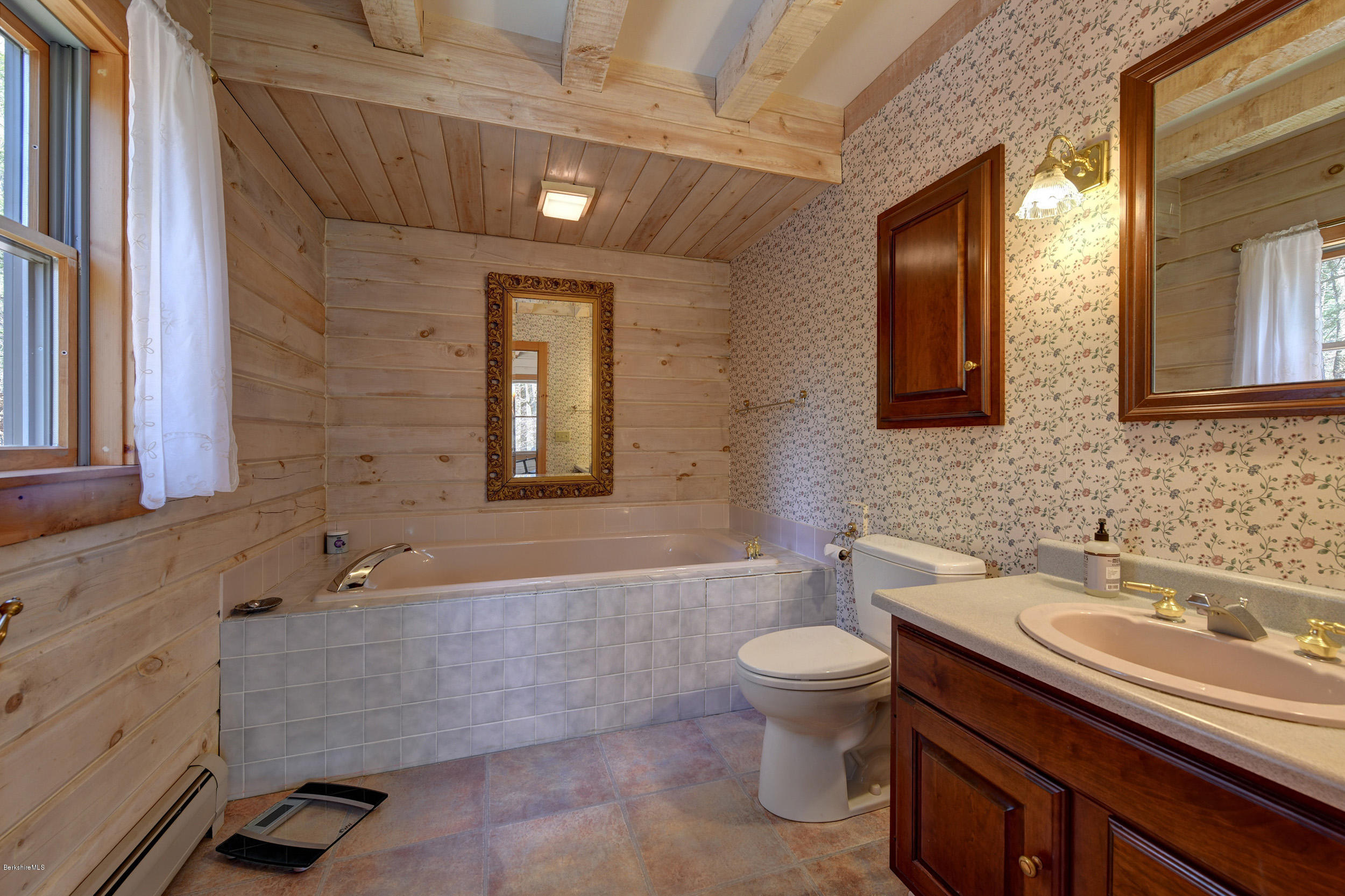 251 Captain Whitney Road Becket, MA 01223 - Photo 18 of 37 a bathroom with a sink a toilet and mirror