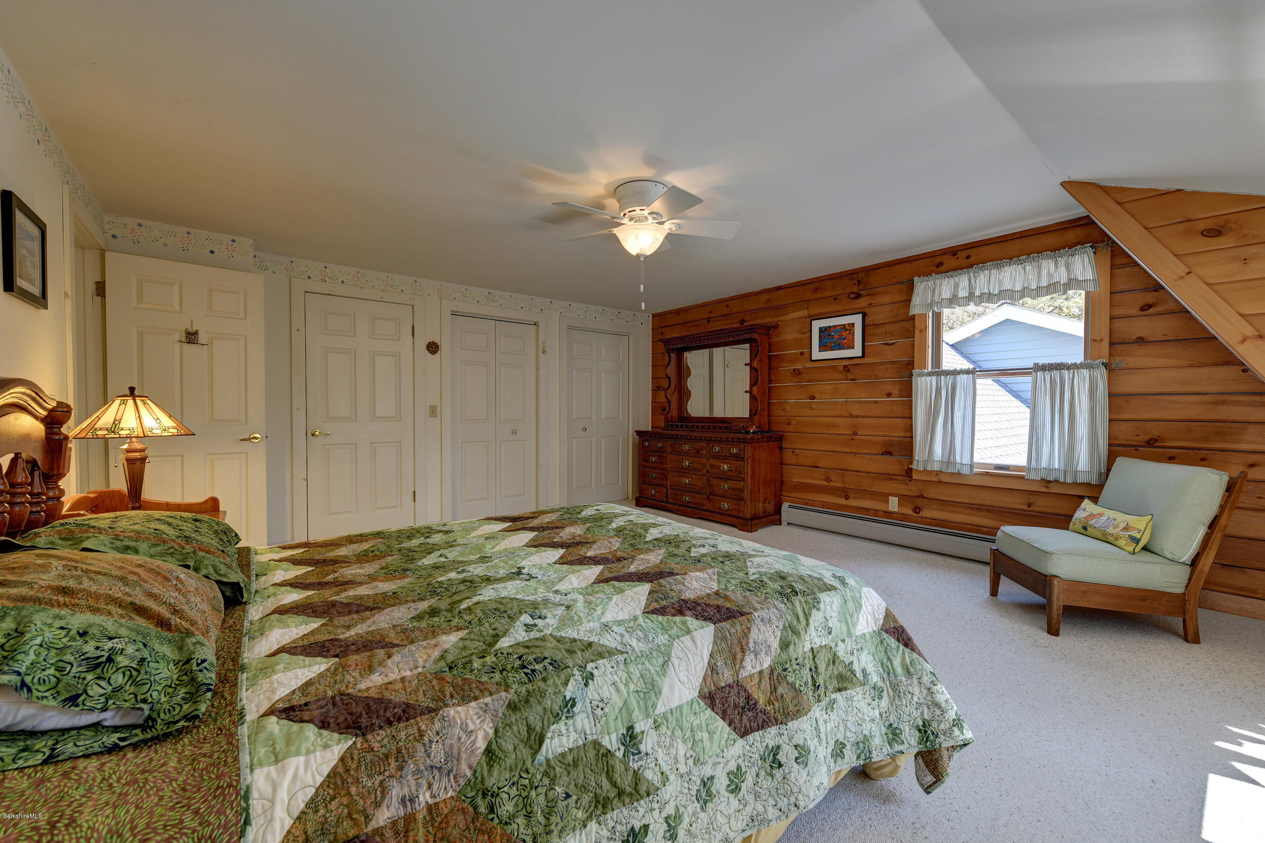 251 Captain Whitney Road Becket, MA 01223 - Photo 23 of 37 a spacious bedroom with a bed and a couch