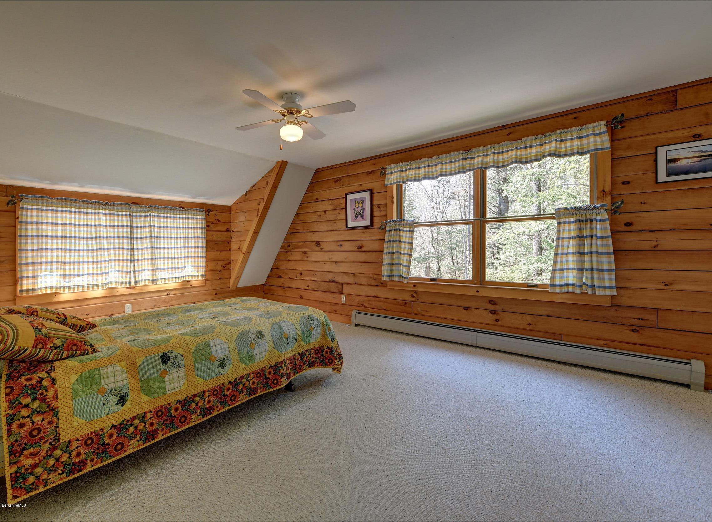 251 Captain Whitney Road Becket, MA 01223 - Photo 24 of 37 a bed sitting in a bedroom next to a window