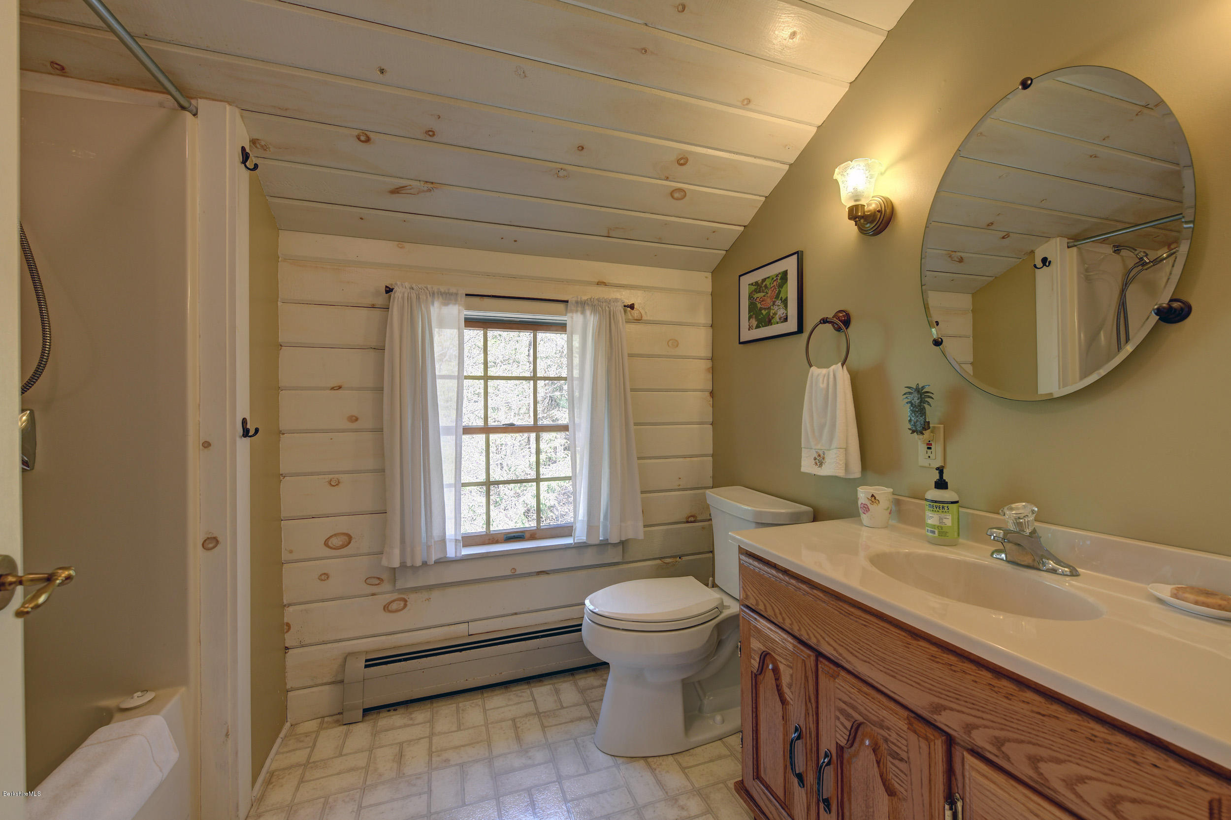 251 Captain Whitney Road Becket, MA 01223 - Photo 28 of 37 a spacious bathroom with a double vanity sink toilet mirror and window
