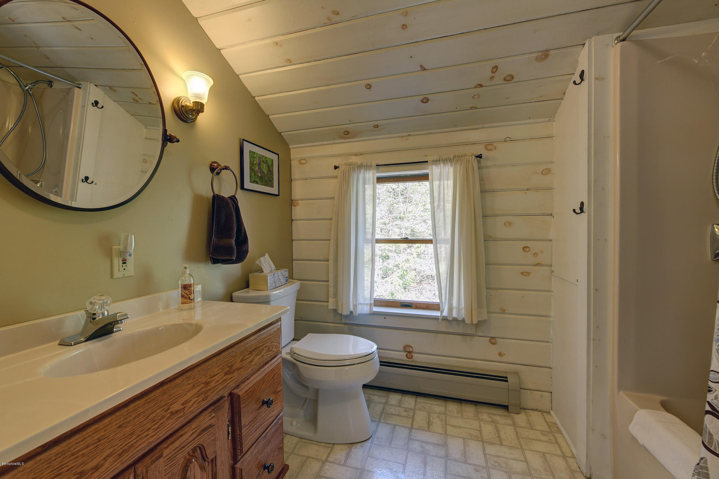 251 Captain Whitney Road Becket, MA 01223 - Photo 29 of 37 a bathroom with a toilet sink and mirror