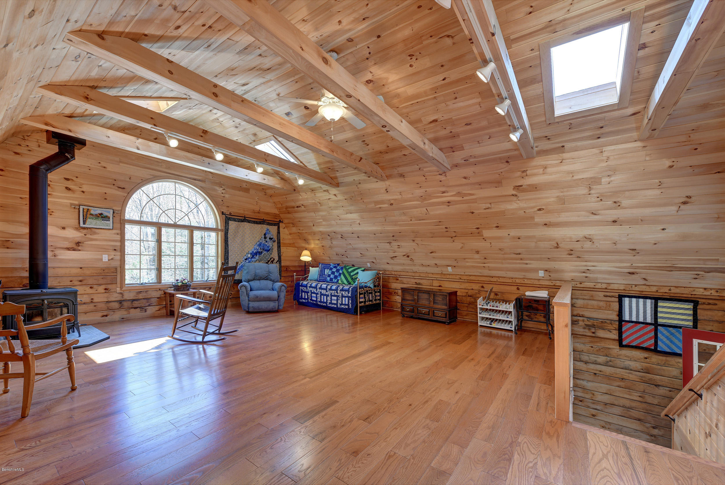 251 Captain Whitney Road Becket, MA 01223 - Photo 30 of 37 a view of a livingroom with furniture hardwood floor and a ceiling fan