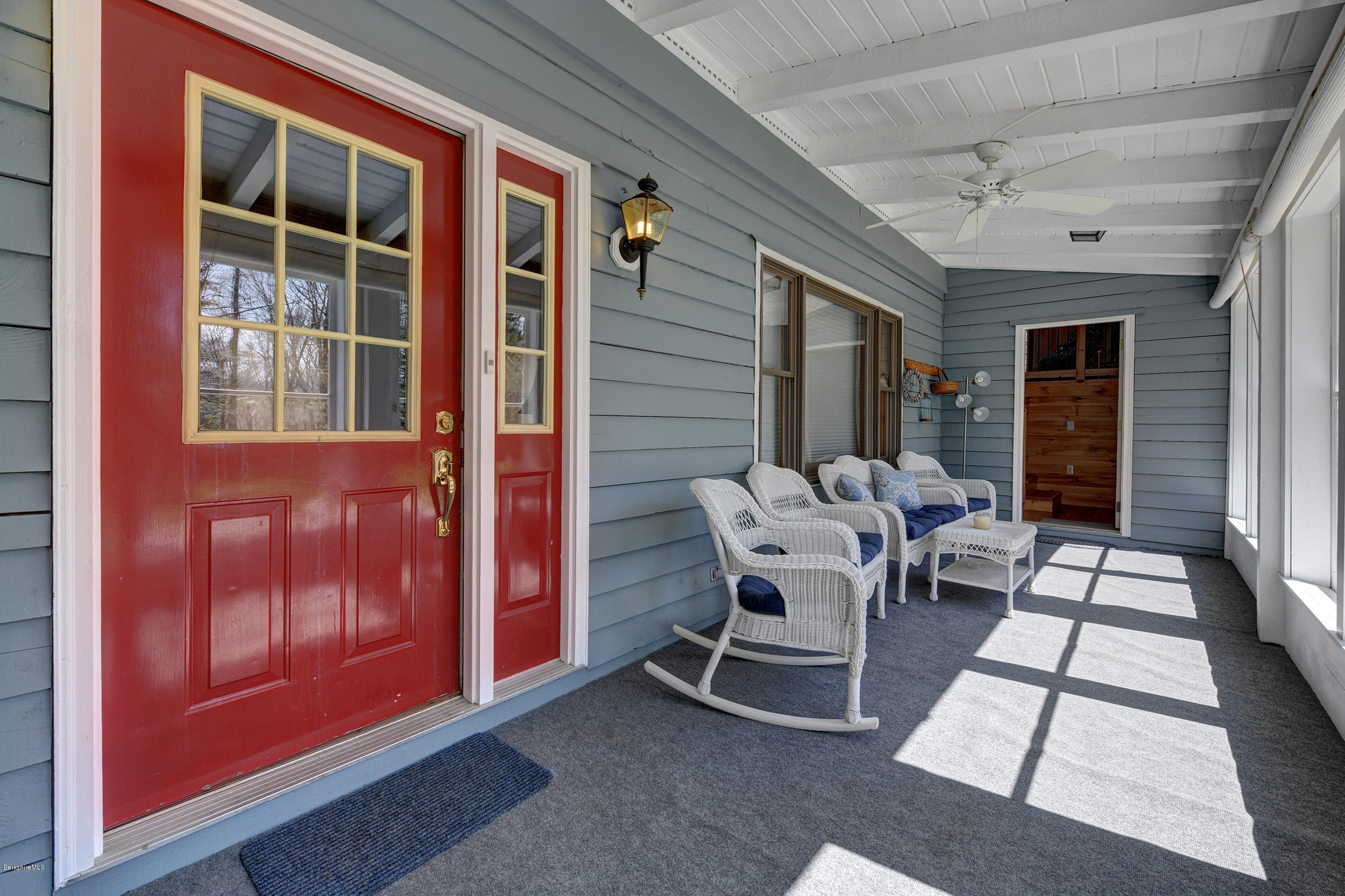 251 Captain Whitney Road Becket, MA 01223 - Photo 4 of 37 a patio with couches and a dining table with balcony view