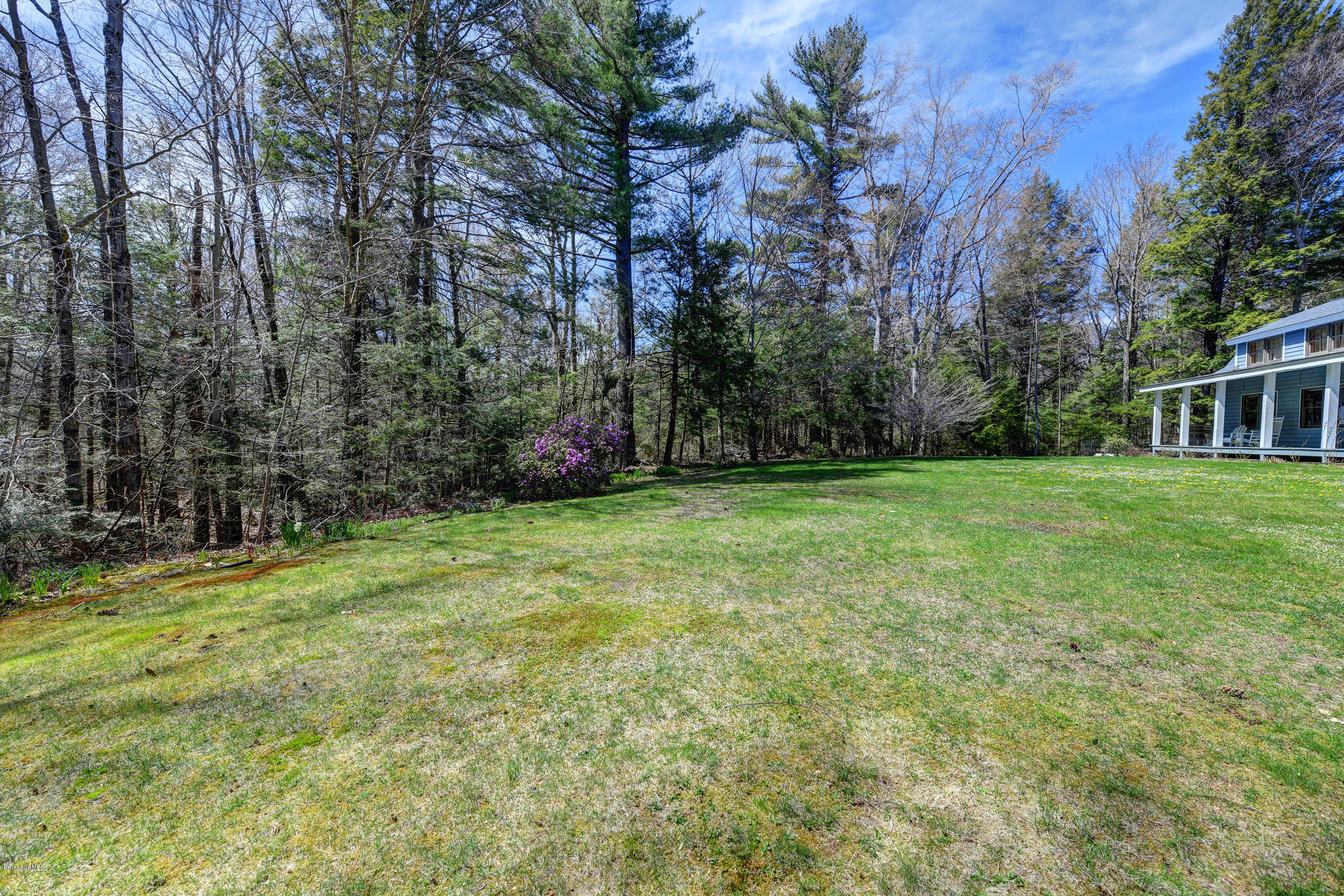 251 Captain Whitney Road Becket, MA 01223 - Photo 35 of 37 a view of a yard with a house in the background