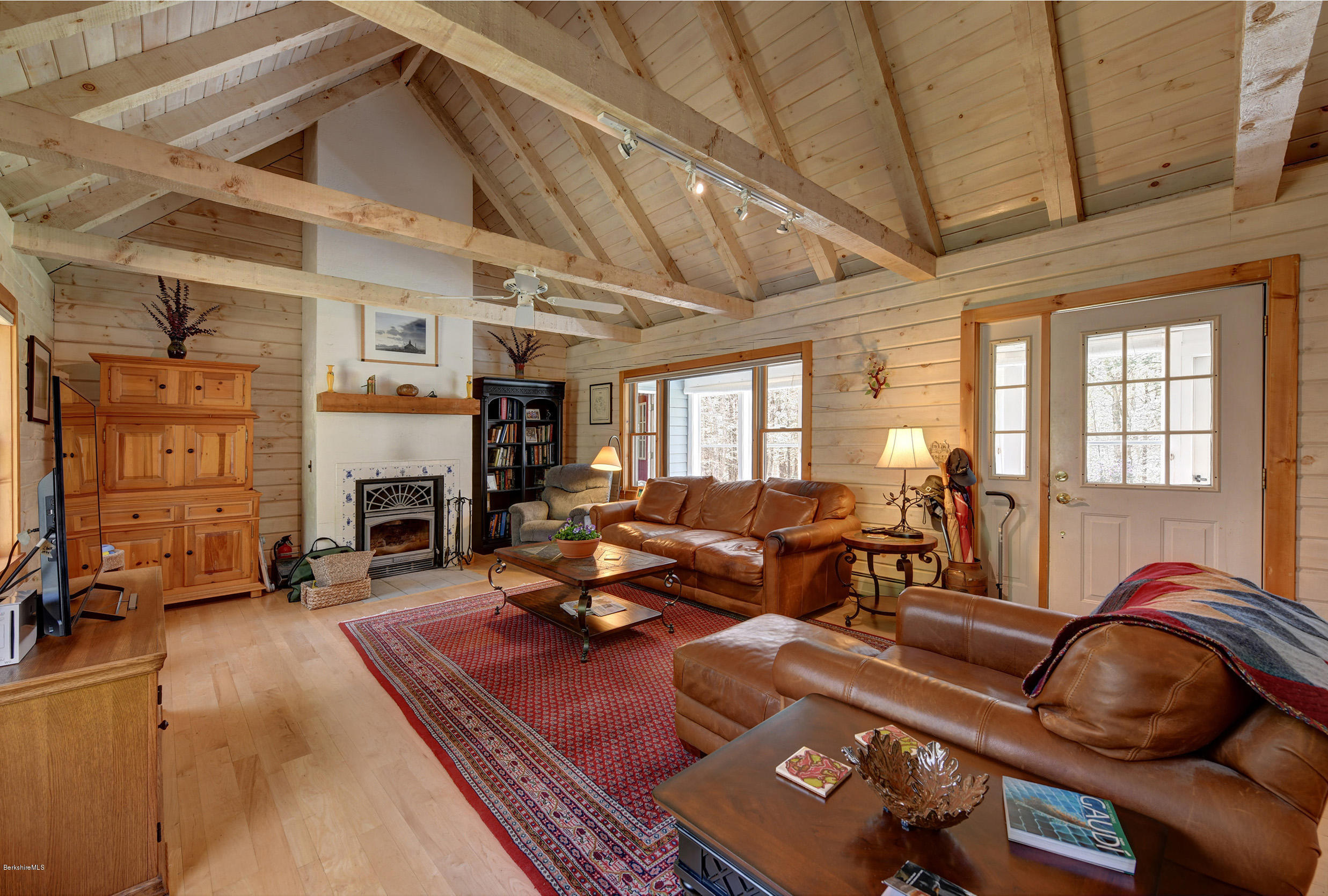 251 Captain Whitney Road Becket, MA 01223 - Photo 7 of 37 a living room with furniture fireplace and a fireplace