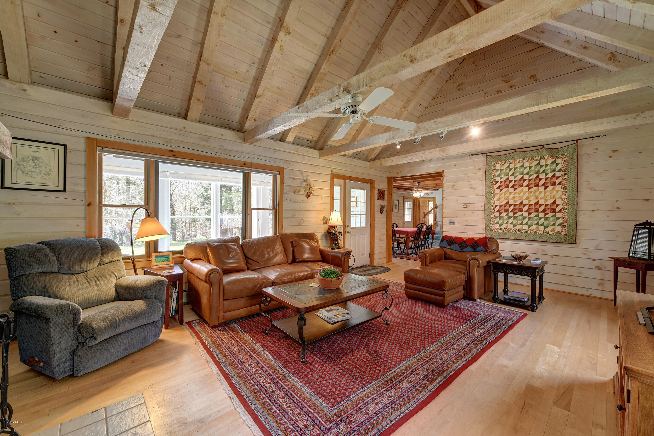 251 Captain Whitney Road Becket, MA 01223 - Photo 8 of 37 a living room with furniture a table and a large window