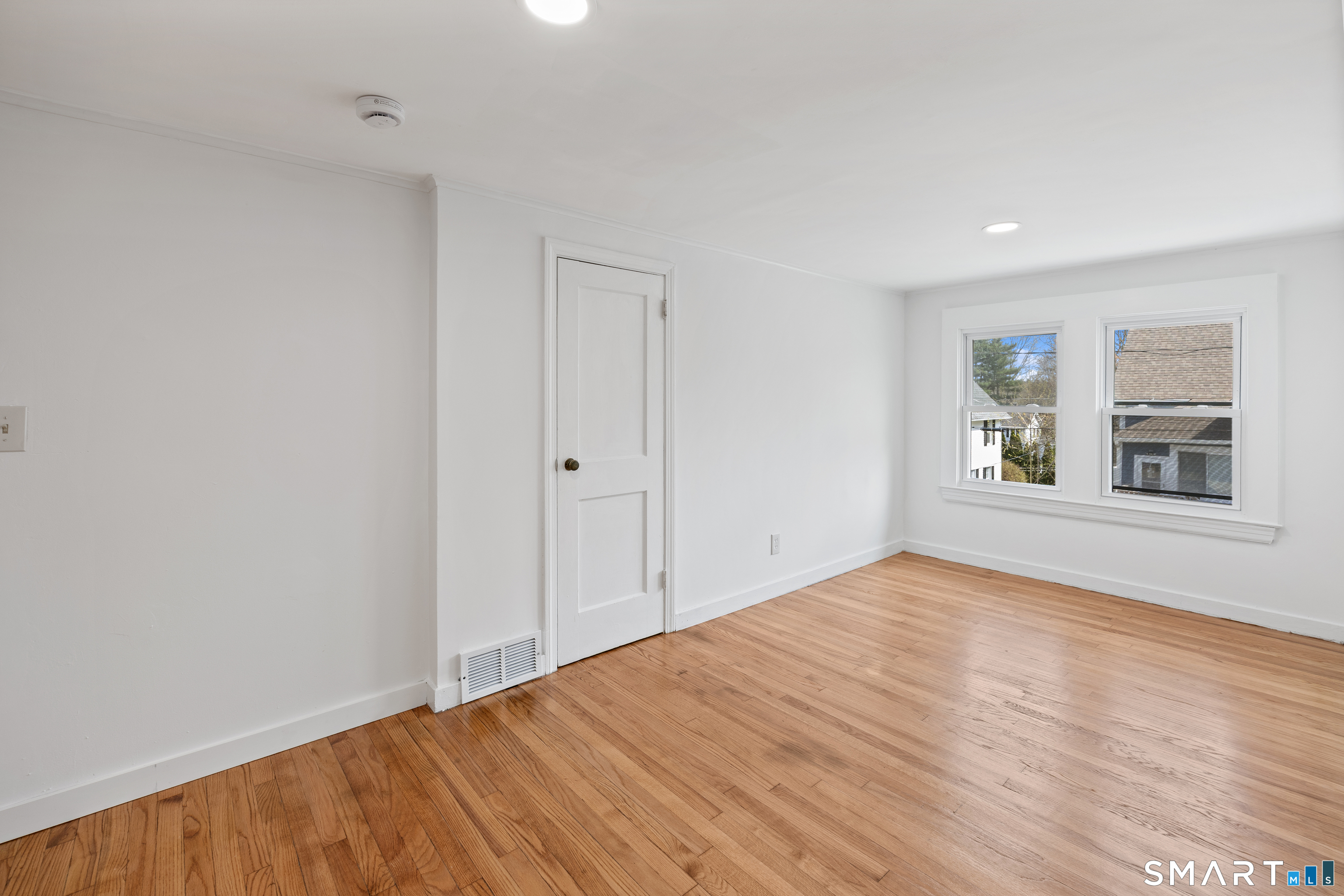 22 Merrimac Street Watertown, CT 06779 - Photo 11 of 17 a view of an empty room with window and wooden floor