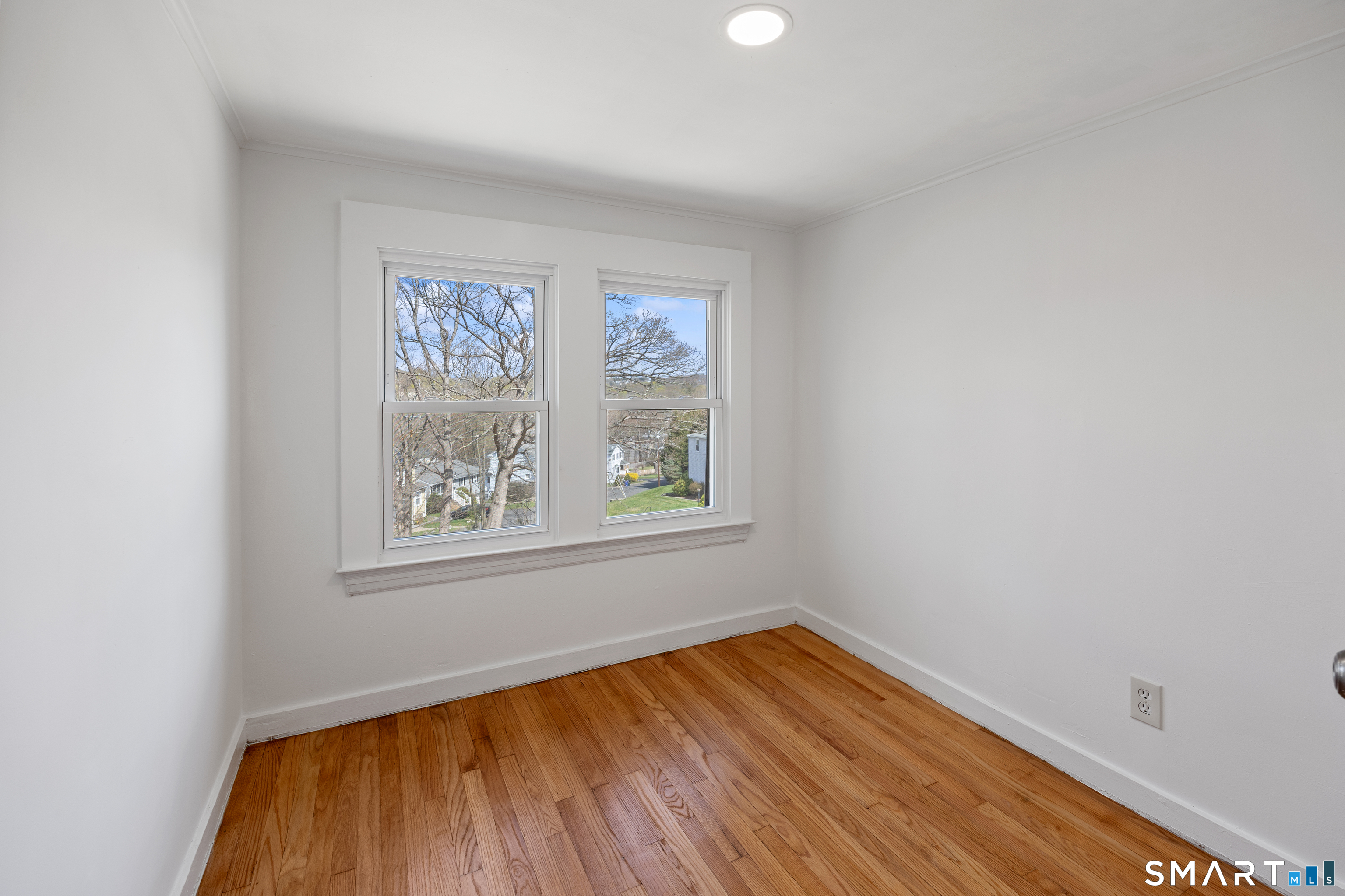 22 Merrimac Street Watertown, CT 06779 - Photo 12 of 17 an empty room with wooden floor and windows