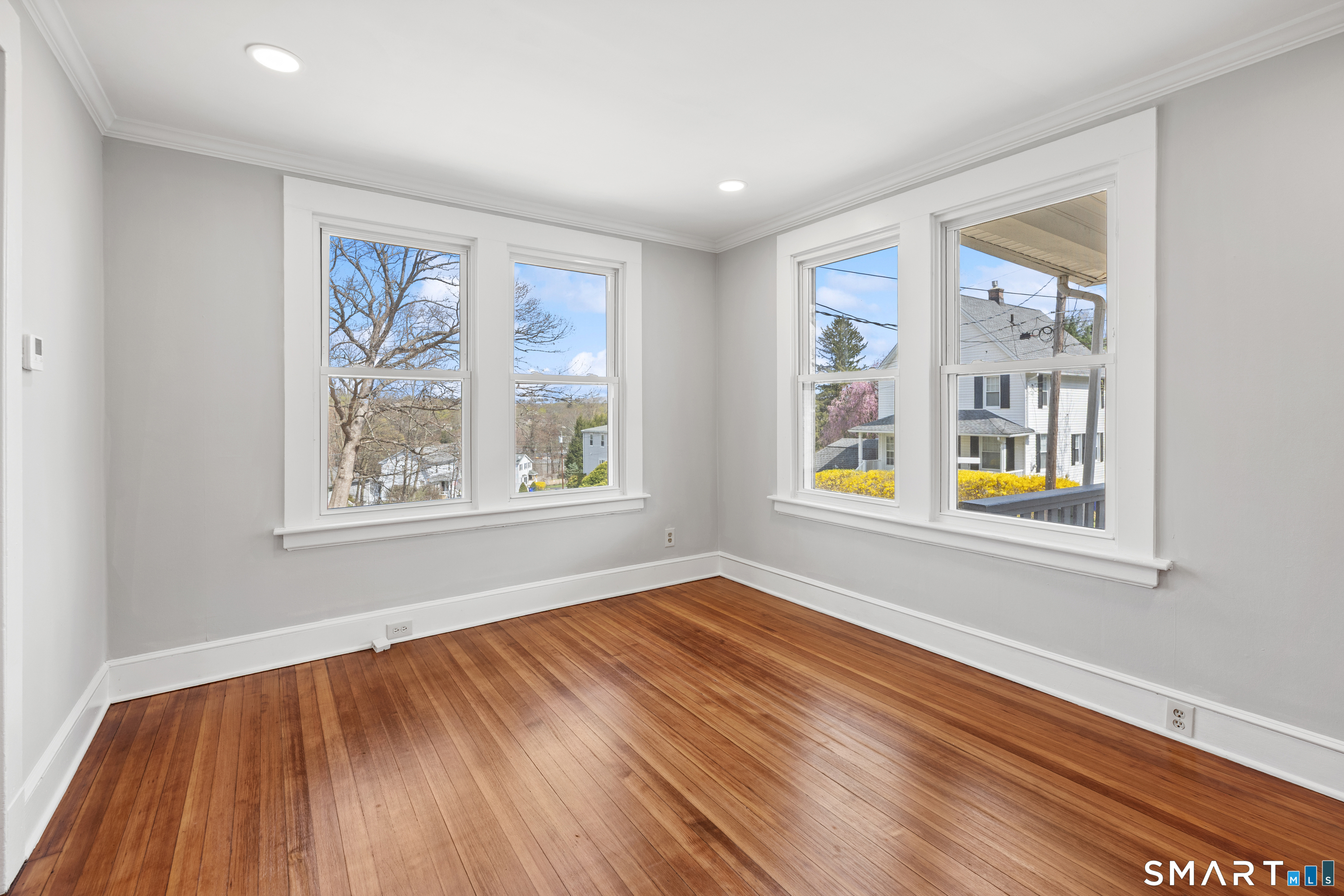 22 Merrimac Street Watertown, CT 06779 - Photo 4 of 17 a view of an empty room with window and wooden floor