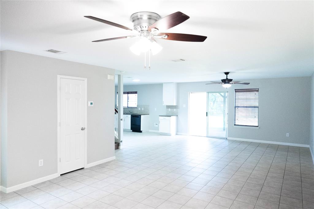 8805 Graywolf Ridge Trail Fort Worth, TX 76244 - Photo 19 of 23 Expansive living area featuring light-toned tile flooring, neutral wall paint, and multiple ceiling fans
