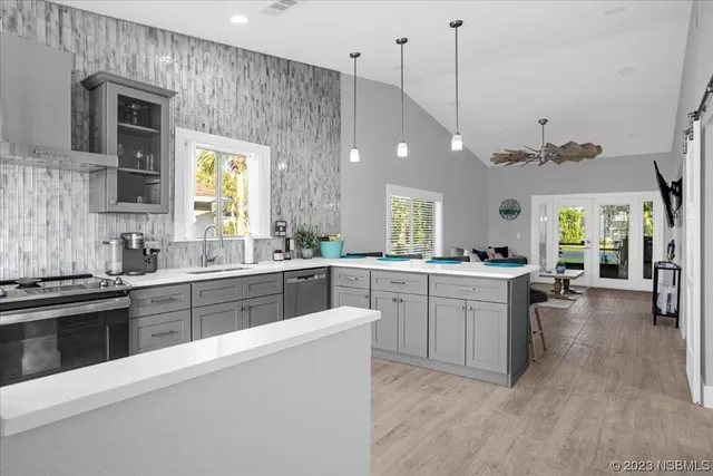 a kitchen with a sink stove and cabinets