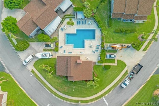 an aerial view of residential house with outdoor space and parking