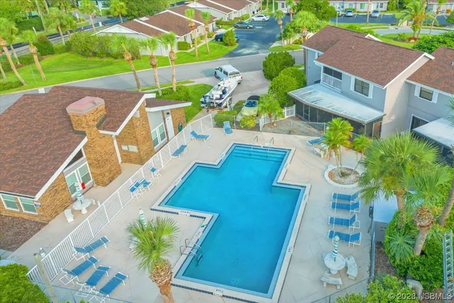 a view of a swimming pool with a lawn chairs