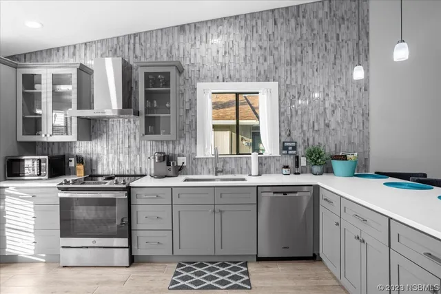 a dining room with wooden floor and stainless steel appliances
