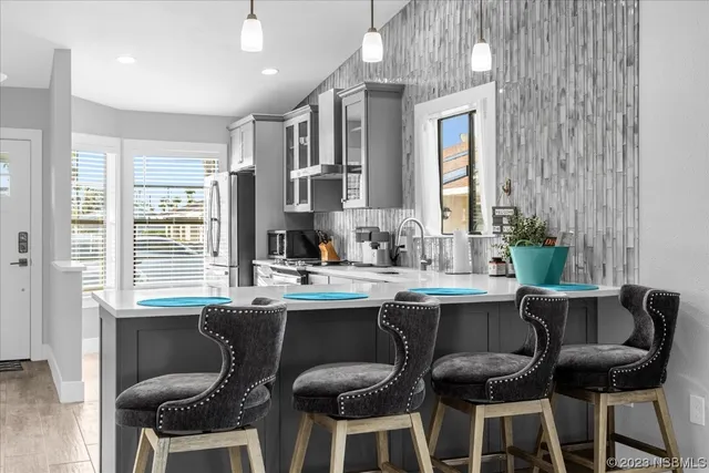 a kitchen with a stove sink and cabinets