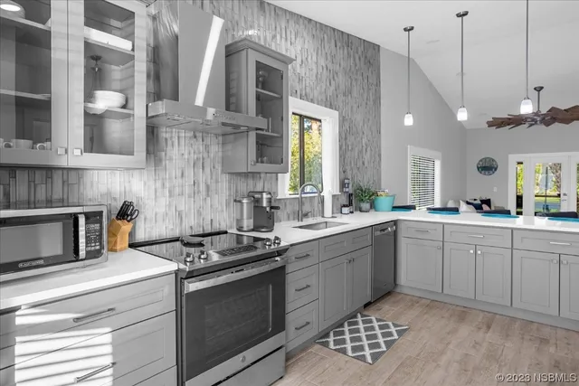 a kitchen with a sink stove and refrigerator
