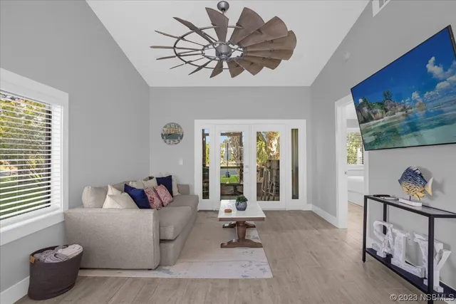a living room with furniture and a wooden floor