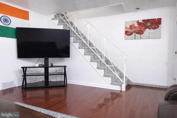 a view of entryway and hall with wooden floor