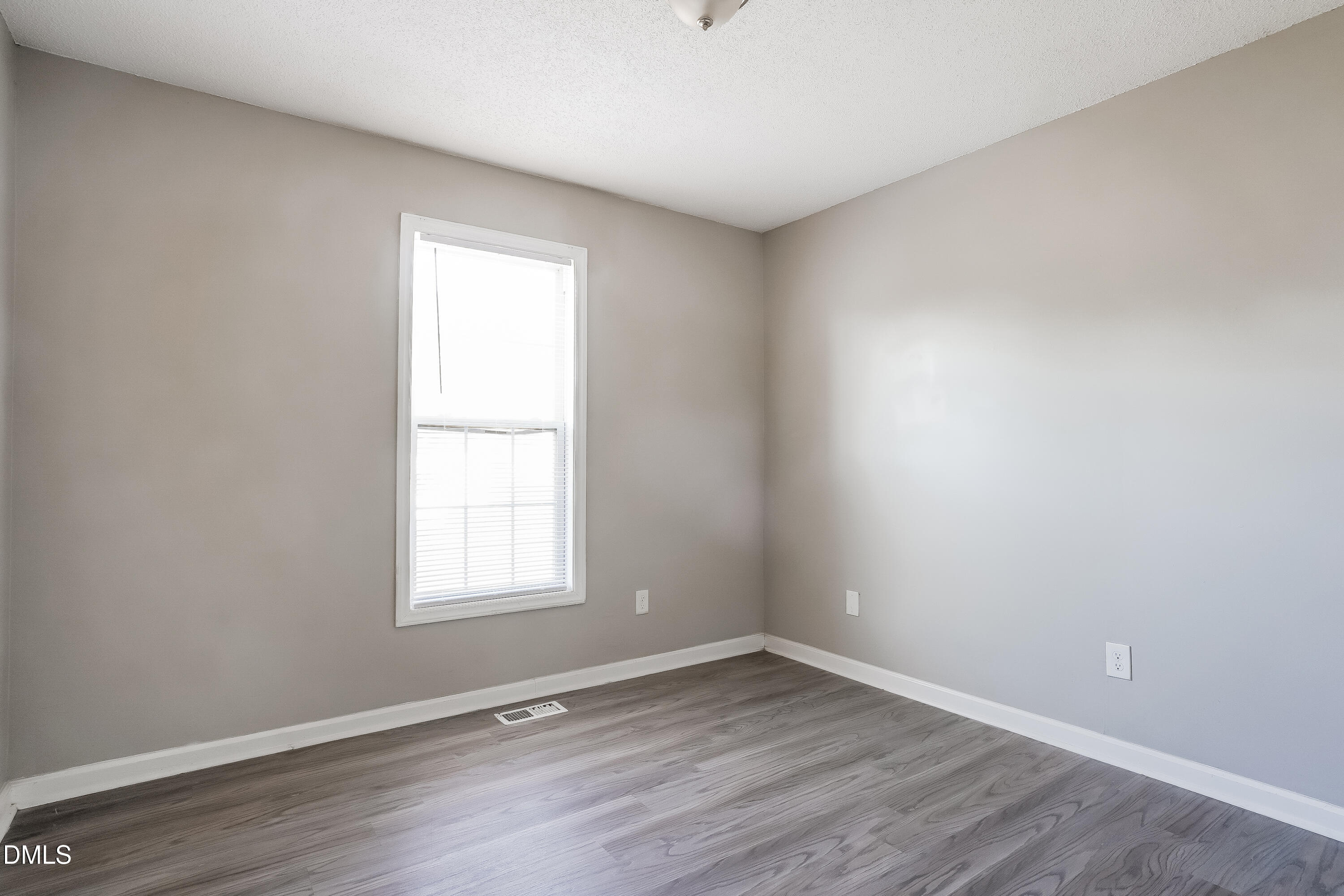 1410 Mandolin Place Zebulon, NC 27597 - Photo 11 of 16 wooden floor in an empty room with a window