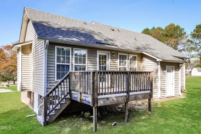 a view of a house with a yard and deck