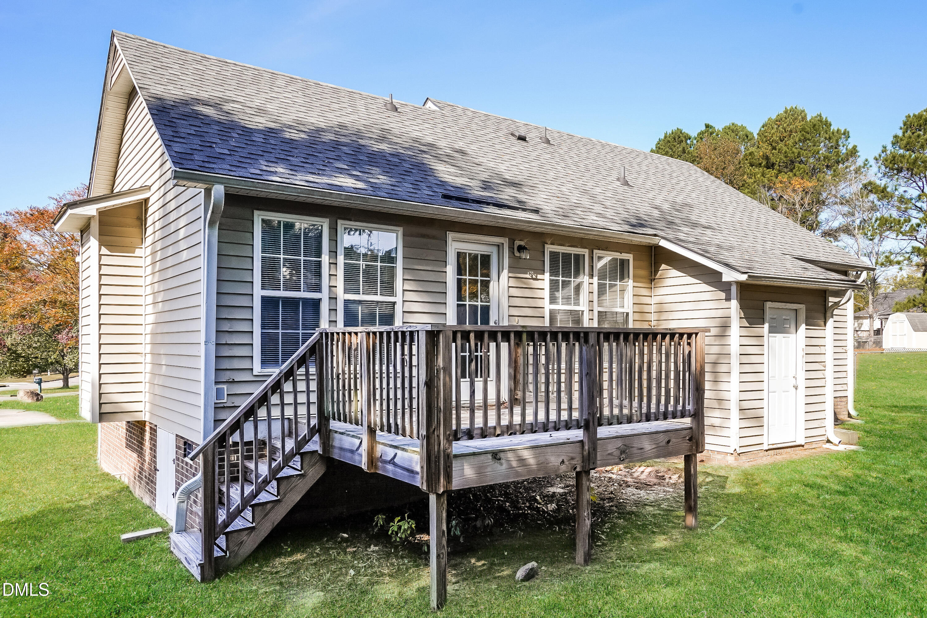 1410 Mandolin Place Zebulon, NC 27597 - Photo 15 of 16 a view of a house with a yard and deck