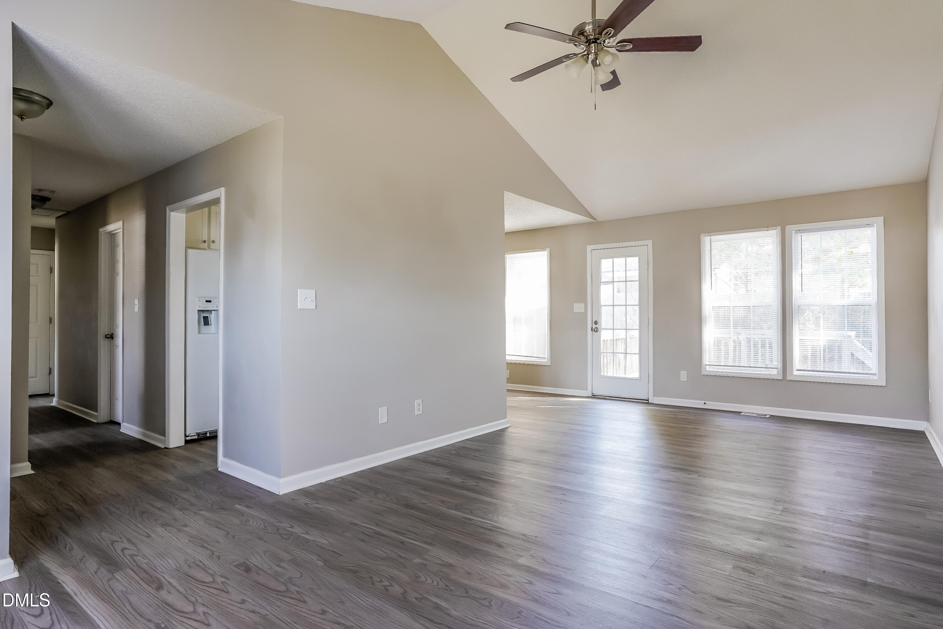 1410 Mandolin Place Zebulon, NC 27597 - Photo 3 of 16 an empty room with wooden floor fan and windows