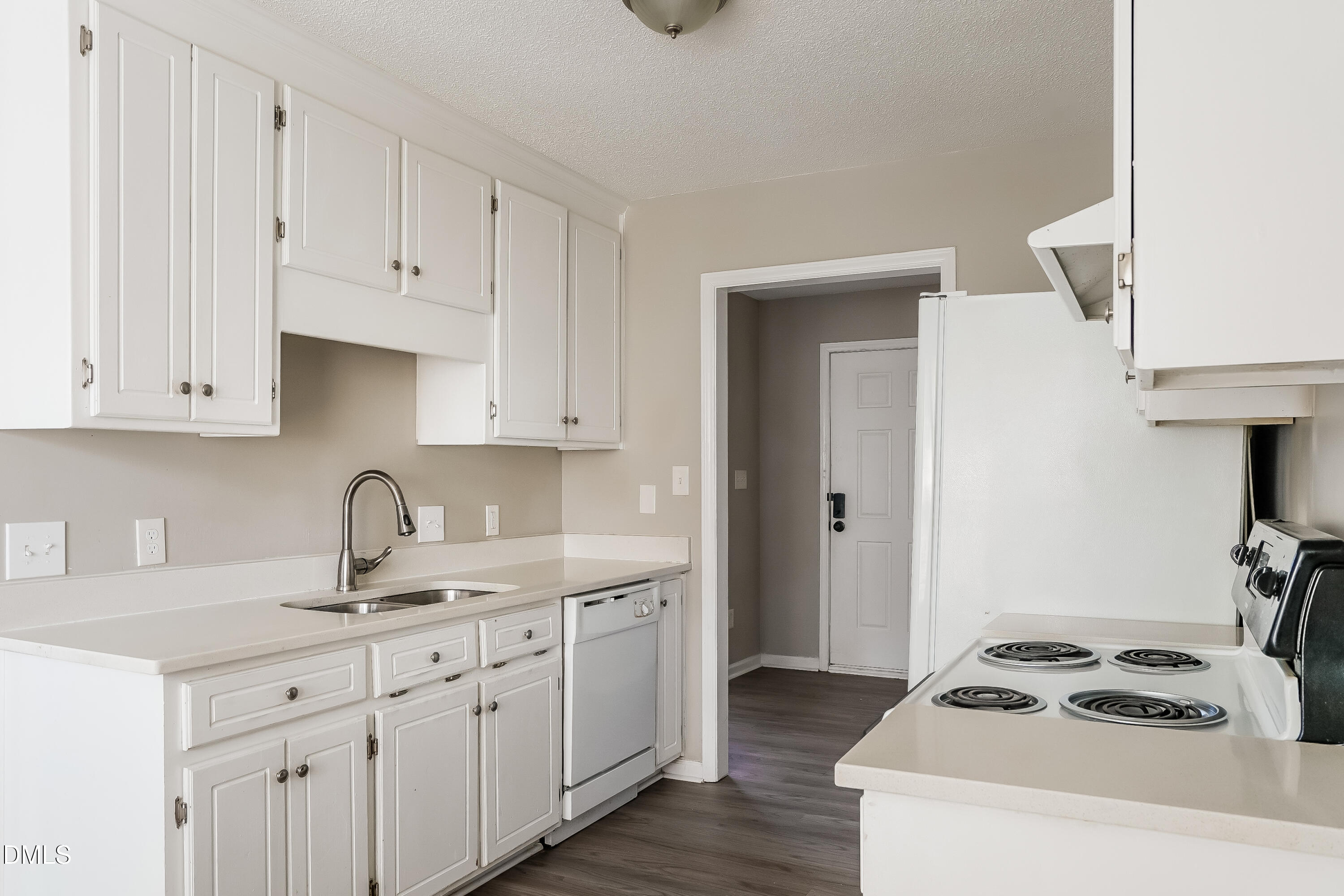 1410 Mandolin Place Zebulon, NC 27597 - Photo 6 of 16 a kitchen with white cabinets and sink