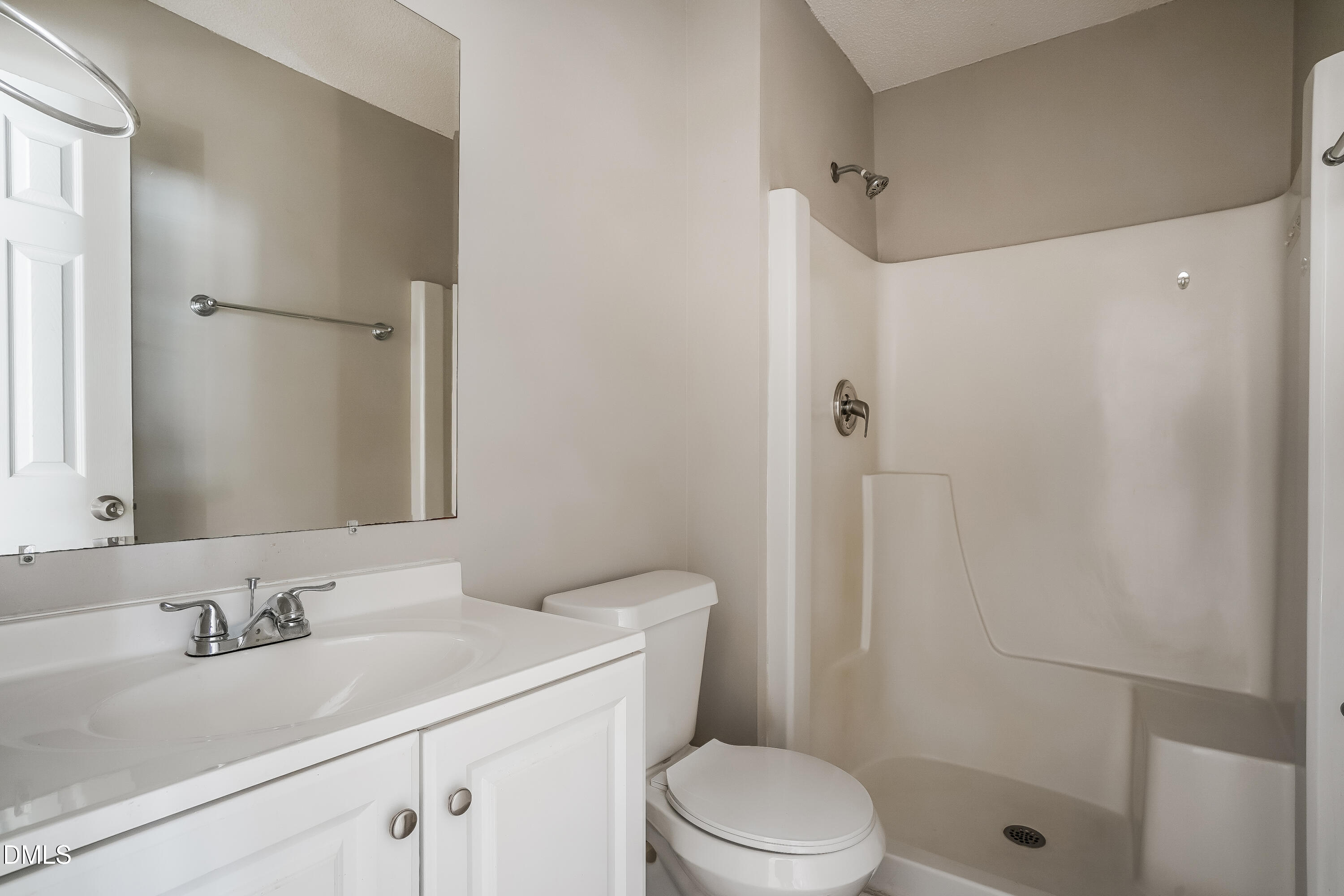 1410 Mandolin Place Zebulon, NC 27597 - Photo 9 of 16 a bathroom with a sink a toilet and shower