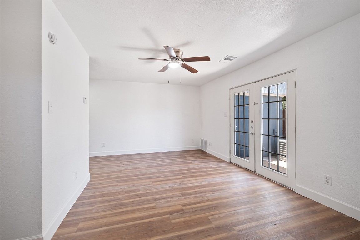 2217 Mission Hill Drive, Unit C Austin, TX 78741 - Photo 1 of 17 wooden floor in an empty room with a window