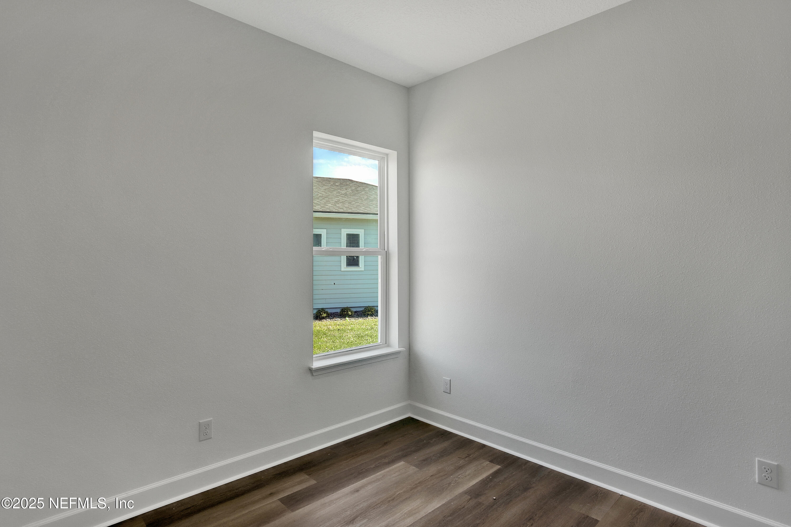 55 Sundance Drive St. Augustine, FL 32092 - Photo 3 of 24 a view of an empty room with a window and wooden floor
