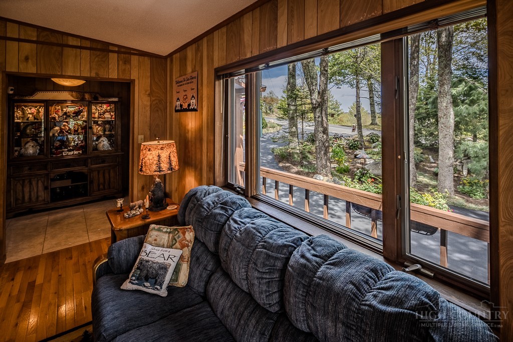103-105 Upper Grouse Ridge Road Beech Mountain, NC 28604 - Photo 15 of 48 a bed sitting in a bedroom next to a window