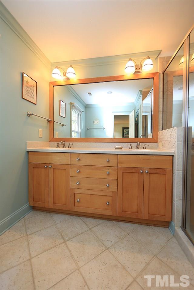 7905 Hardwick Drive Raleigh, NC 27615 - Photo 15 of 26 The master bath is tastefully updated, large tile floors, his and hers sinks, not pictured a linen closet