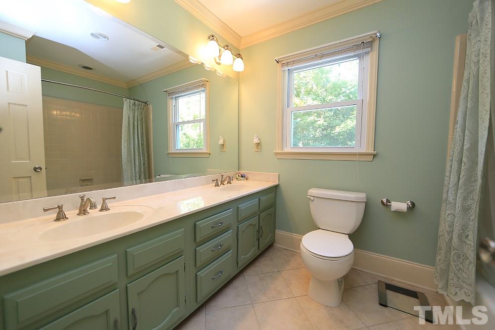7905 Hardwick Drive Raleigh, NC 27615 - Photo 19 of 26 Updated large tile flooring, double sinks, tiled tub surround!