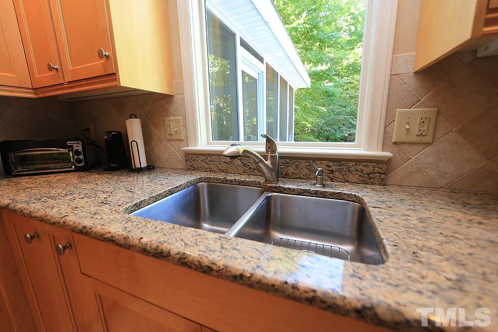 7905 Hardwick Drive Raleigh, NC 27615 - Photo 6 of 26 Large window over the sink with views to the back yard. Granite counters too!