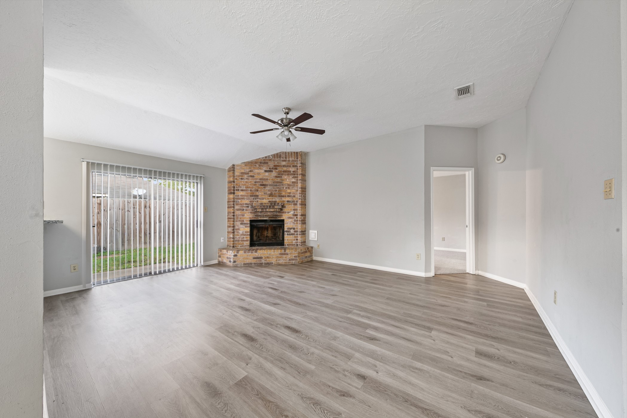 10530 Rippling Fields Drive Houston, TX 77064 - Photo 13 of 30 a view of empty room with wooden floor and fireplace